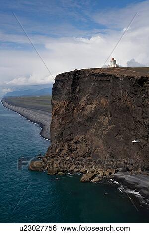 Stock Photograph - Lighthouse on remote cliff. Fotosearch