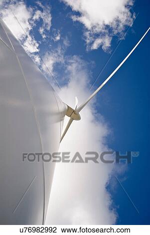 Stock Image - Low angle view of wind turbine. Fotosearch