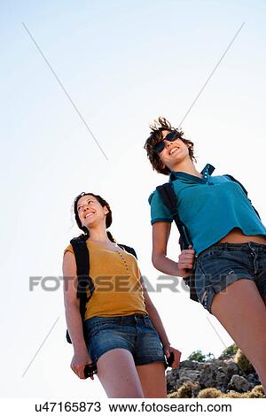 Stock Image - Low angle view of women outdoors. Fotosearch