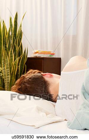 Stock Image - Man asleep in bed. Fotosearch