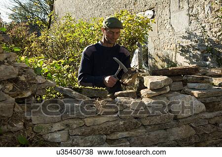 Man building stone wall View Large Photo Image Stock Photo - Man building stone wall. Fotosearch