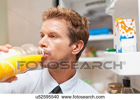 Man drinking juice out of bottle View Large Photo Image Stock Image - Man drinking juice out of bottle. Fotosearch
