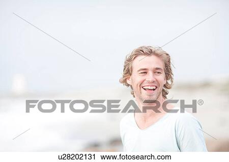Man enjoying breeze on beach View Large Photo Image Stock Image - Man enjoying breeze on beach. Fotosearch