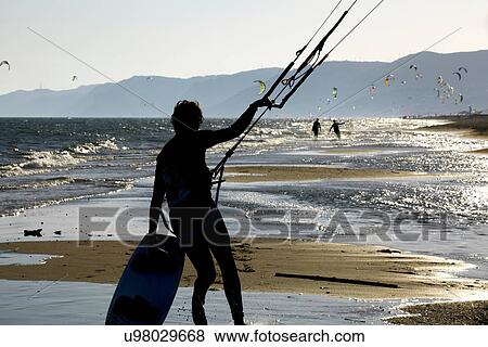 Man flying kites on beach View Large Photo Image Stock Photo - Man flying kites on beach. Fotosearch