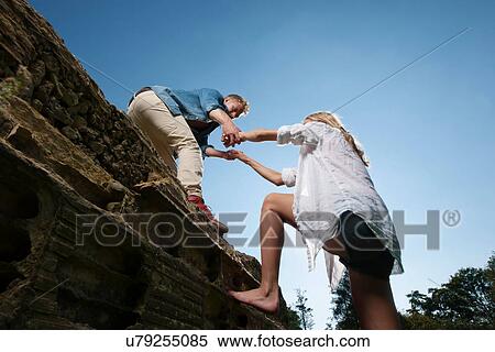 Man helping girlfriend climb wall View Large Photo Image Stock Photography - Man helping girlfriend climb wall. Fotosearch