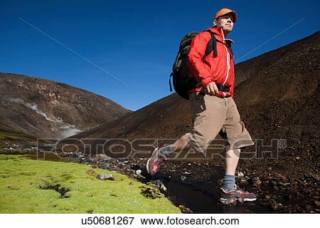 Man hiking in rocky rural creek View Large Photo Image Stock Photo - Man hiking in rocky rural creek. Fotosearch