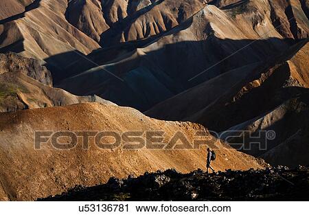 Man hiking in rocky rural landscape View Large Photo Image Stock Image - Man hiking in rocky rural landscape. Fotosearch