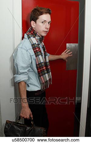 Man in scarf opening door View Large Photo Image Stock Image - Man in scarf opening door. Fotosearch