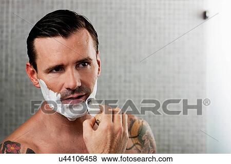 Man lathering shaving cream on face View Large Photo Image Stock Photo - Man lathering shaving cream on face. Fotosearch
