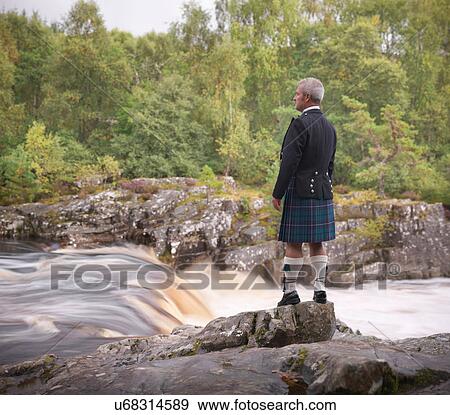 Man looking over flowing river in traditional Scottish Prince Charlie outfit with Douglas Modern Tartan View Large Photo Image Stock Photo - Man looking over flowing river in traditional Scottish Prince Charlie outfit with Douglas Modern Tartan. Fotosearch