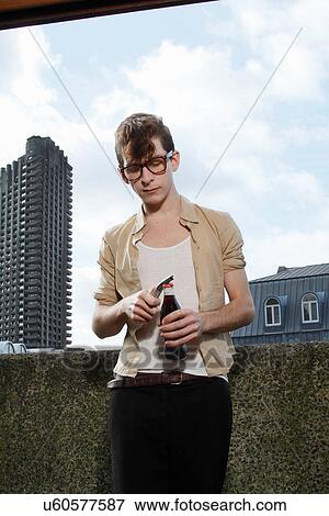 Man opening soda with bottle opener View Large Photo Image Stock Photo - Man opening soda with bottle opener. Fotosearch