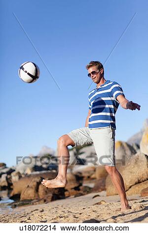 Man playing soccer on beach View Large Photo Image Picture - Man playing soccer on beach. Fotosearch