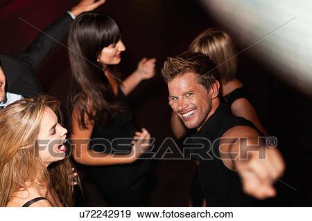 Man pointing and dancing in club View Large Photo Image Stock Photo - Man pointing and dancing in club. Fotosearch