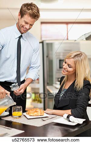 Man pouring juice at breakfast View Large Photo Image Stock Image - Man pouring juice at breakfast. Fotosearch