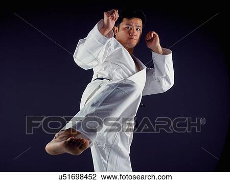 Man practicing martial arts View Large Photo Image Stock Image - Man practicing martial arts. Fotosearch