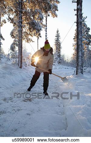 Man shoveling snow on rural path View Large Photo Image Stock Image - Man shoveling snow on rural path. Fotosearch