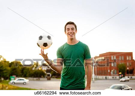 Man spinning soccer ball on finger View Large Photo Image Picture - Man spinning soccer ball on finger. Fotosearch