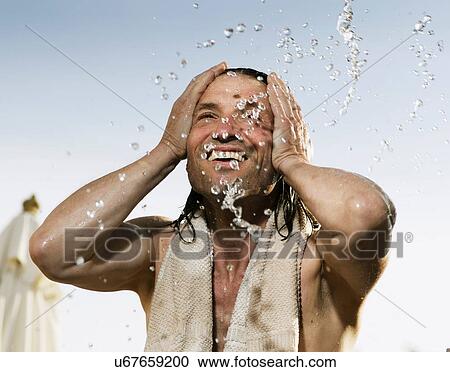 Man splashing his face with water View Large Photo Image Stock Image - Man splashing his face with water. Fotosearch