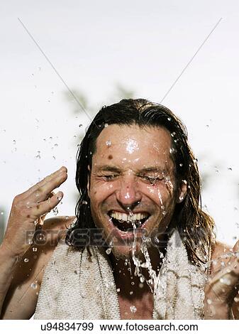 Man splashing his face with water View Large Photo Image Stock Photo - Man splashing his face with water. Fotosearch