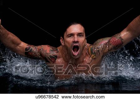 Man splashing in swimming pool View Large Photo Image Stock Image - Man splashing in swimming pool. Fotosearch