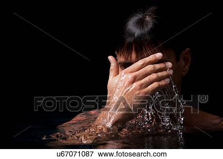 Stock Photo - Man swimming in pool at night. Fotosearch
