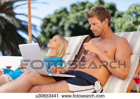 Man using laptop in lawn chair View Large Photo Image Stock Image - Man using laptop in lawn chair. Fotosearch