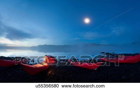 Man using light to examine canoes View Large Photo Image Stock Image - Man using light to examine canoes. Fotosearch