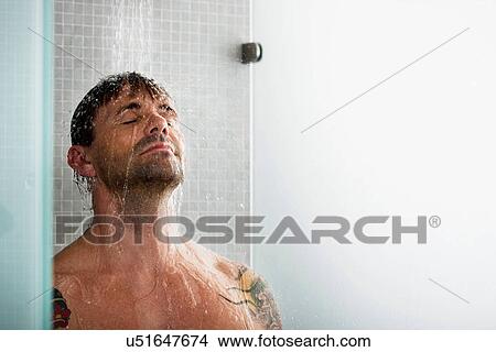 Picture - Man washing his hair in shower. Fotosearch