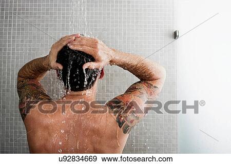 Stock Photo - Man washing his hair in shower. Fotosearch