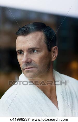 Man wearing bathrobe in bathroom View Large Photo Image Stock Photo - Man wearing bathrobe in bathroom. Fotosearch