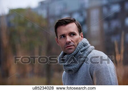 Man wearing knitted scarf outdoors View Large Photo Image Stock Photo - Man wearing knitted scarf outdoors. Fotosearch