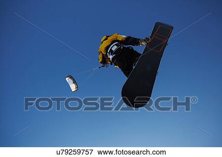 Man windsurfing on snowboard View Large Photo Image Stock Photo - Man windsurfing on snowboard. Fotosearch