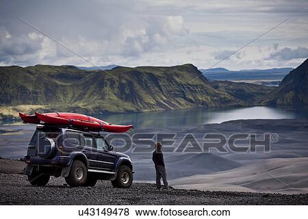Stock Photo - Man with Jeep admiring rural landscape. Fotosearch