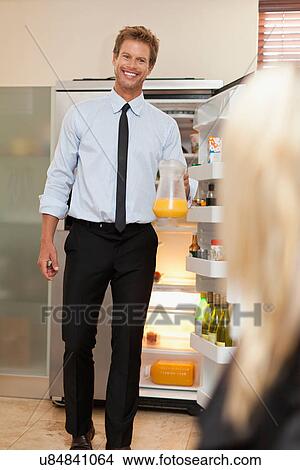 Picture - Man with pitcher of juice. Fotosearch