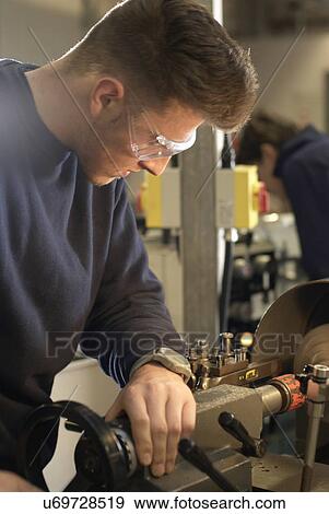 Stock Photo - Mechanic working on car engine. Fotosearch