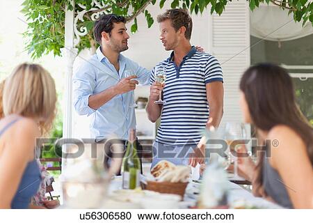 Men having wine at table outdoors View Large Photo Image Stock Image - Men having wine at table outdoors. Fotosearch