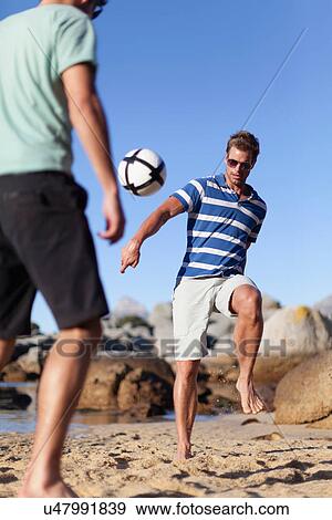 Men playing soccer on beach View Large Photo Image Stock Photo - Men playing soccer on beach. Fotosearch