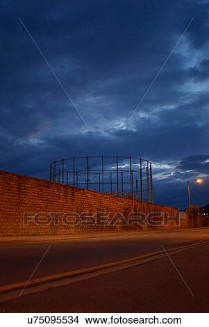 Picture - Metal structure behind brick wall. Fotosearch