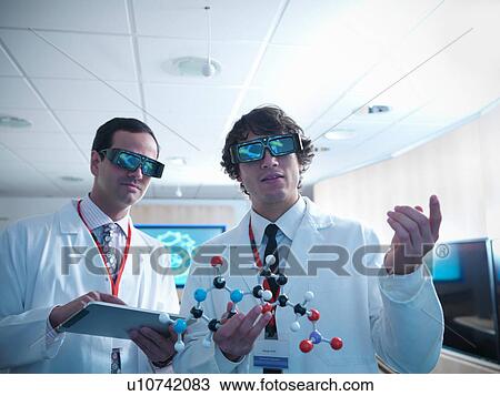Molecular scientist and apprentice in 3D glasses holding molecular model and digital tablet View Large Photo Image Stock Image - Molecular scientist and apprentice in 3D glasses holding molecular model and digital tablet. Fotosearch
