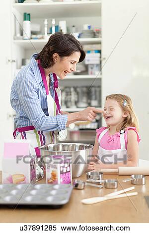 Mother and daughter baking in kitchen View Large Photo Image Stock Photography - Mother and daughter baking in kitchen. Fotosearch