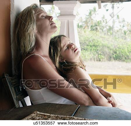 Mother and daughter sleeping in chair View Large Photo Image Stock Photo - Mother and daughter sleeping in chair. Fotosearch