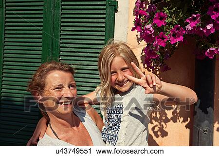 Stock Image - Mother and daughter smiling together. Fotosearch