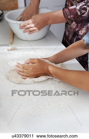 Stock Image - Mother and son baking together. Fotosearch