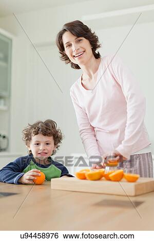 Stock Photograph - Mother and son having breakfast. Fotosearch
