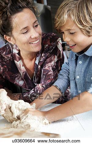 Mother and son sitting outdoors View Large Photo Image Picture - Mother and son sitting outdoors. Fotosearch
