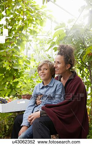 Mother and son sitting outdoors View Large Photo Image Stock Image - Mother and son sitting outdoors. Fotosearch