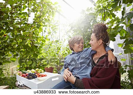 Mother and son sitting outdoors View Large Photo Image Stock Image - Mother and son sitting outdoors. Fotosearch