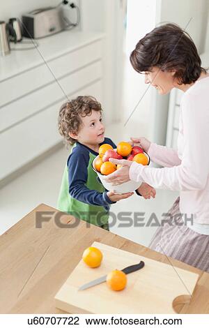 Mother and son with fruit in kitchen View Large Photo Image Stock Image - Mother and son with fruit in kitchen. Fotosearch