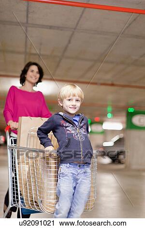 Mother grocery shopping with son View Large Photo Image Stock Image - Mother grocery shopping with son. Fotosearch