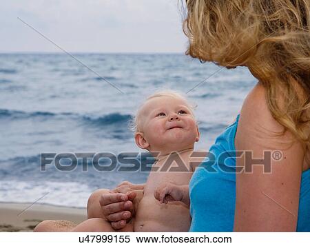 Mother holding baby on beach View Large Photo Image Stock Photography - Mother holding baby on beach. Fotosearch
